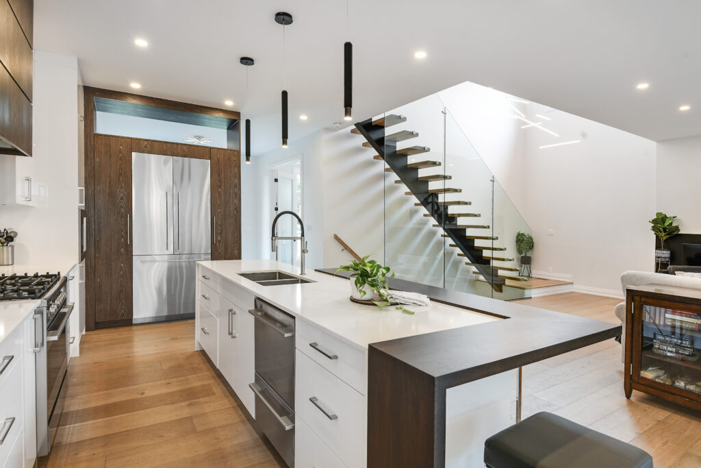 well-designed kitchen with a staircase that leads to an upper area, emphasizing a blend of functionality and style.